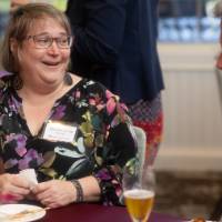 faculty around table enjoying each others company